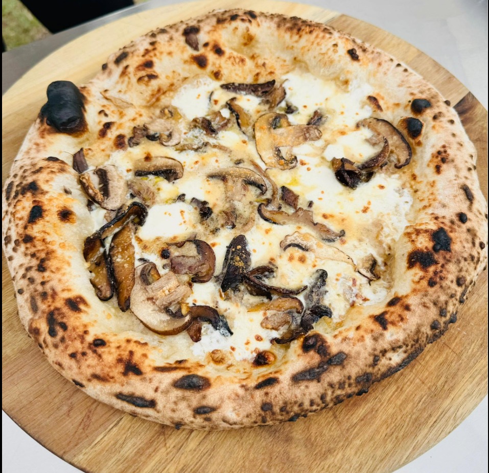 Wood-fired Pizza Funghi with porcini, mushrooms and truffle oil at The Warehouse Pizzeria
