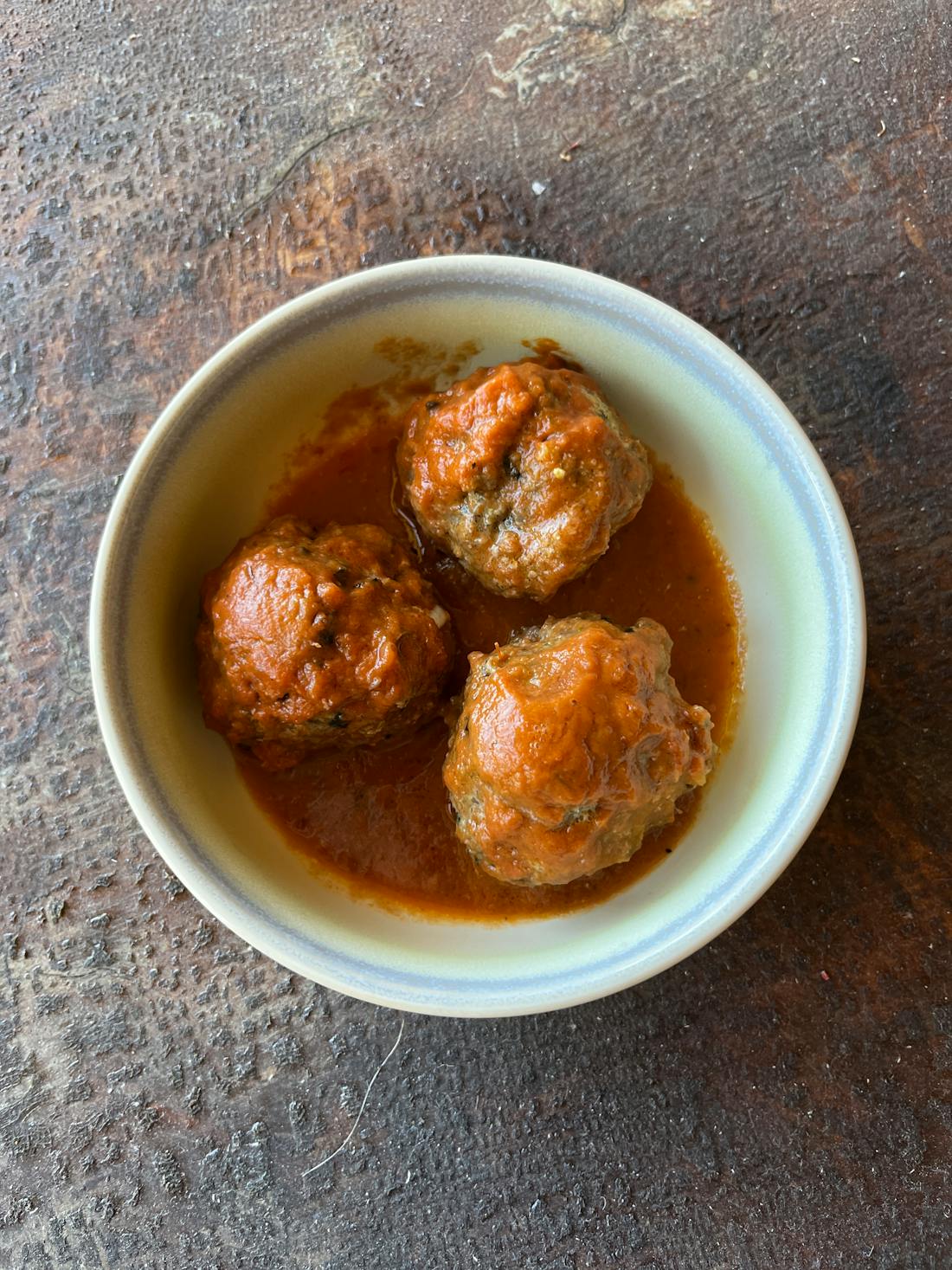 Beef and pork polpette meatballs in slow-cooked San Marzano tomato sauce