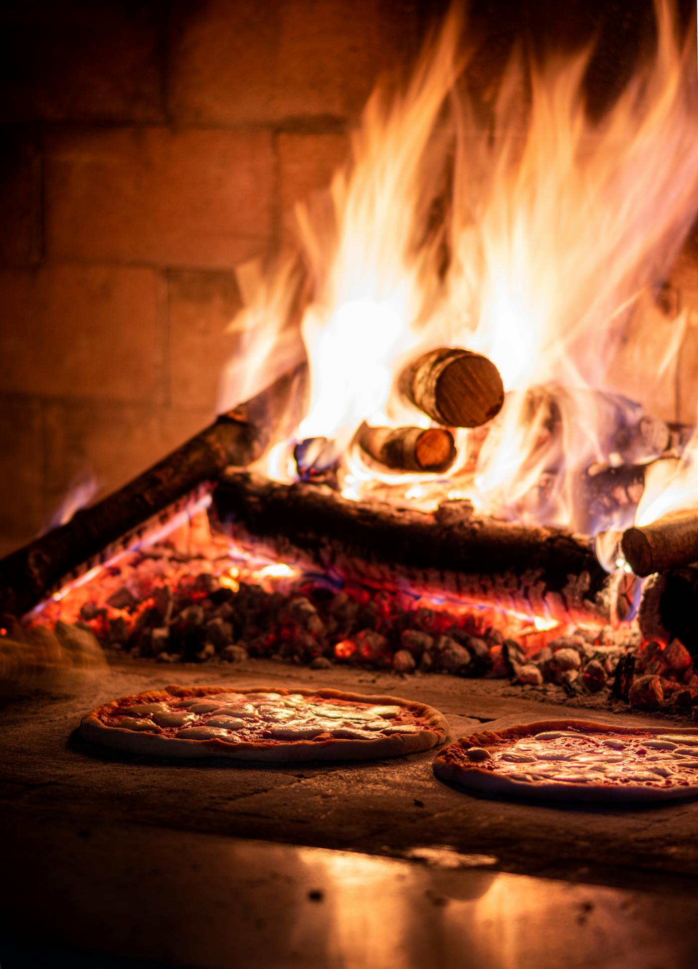 Pizzas baking in the 450°C wood-fired stone oven at The Warehouse Pizzeria, Preston